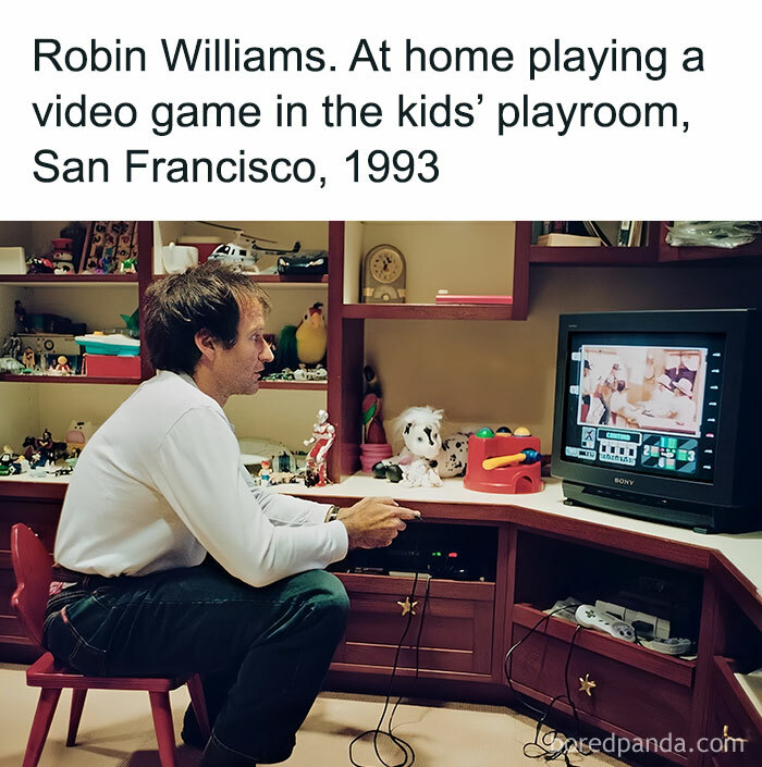 Man playing a video game in a '90s playroom, San Francisco, 1993.