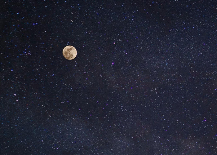 Moon in a starry night sky, evoking a sense of whimsy and wonder.