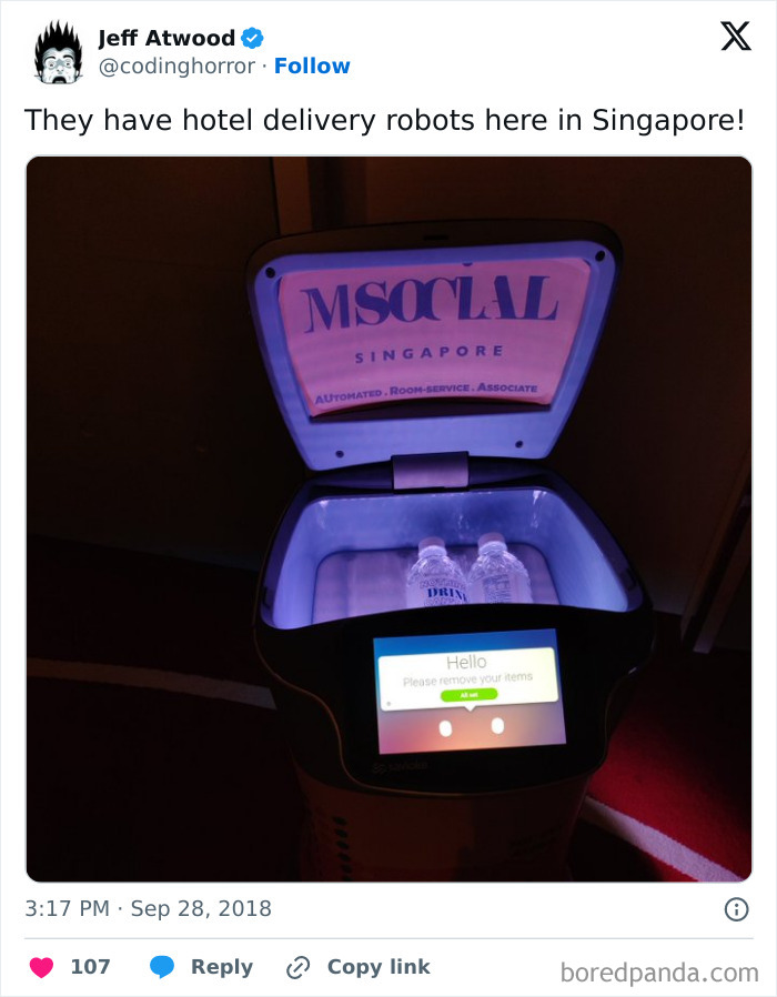 Hotel delivery robot in Singapore with open lid revealing bottled water, showcasing tourist-interesting experiences.
