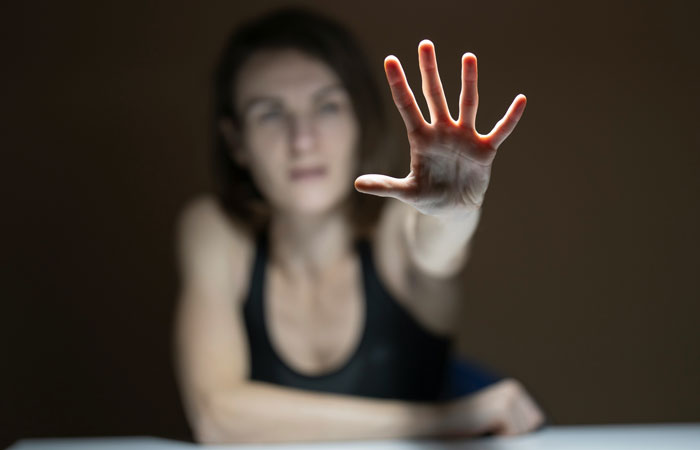 Blurry woman reaching out with hand extended, depicted as the "prettiest girl" concept from high school memories.