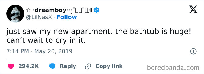 Tweet about an apartment's large bathtub, reflecting on an existential moment.