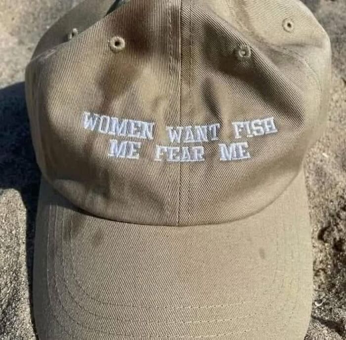 A beige cap on sand with "Women want fish, men fear me" text, showcasing weird images.