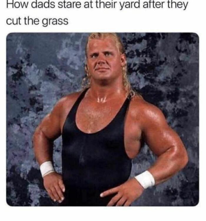 Muscular man in a black tank top posing humorously, capturing dad humor essence.