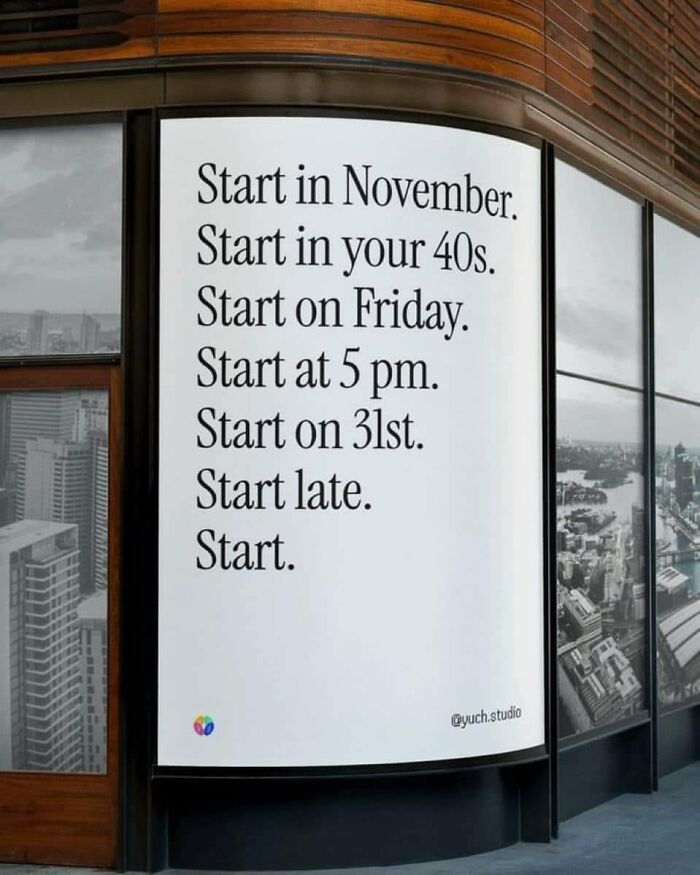 Sign on a building with motivational phrases emphasizing the word "Start," promoting daily positivity.