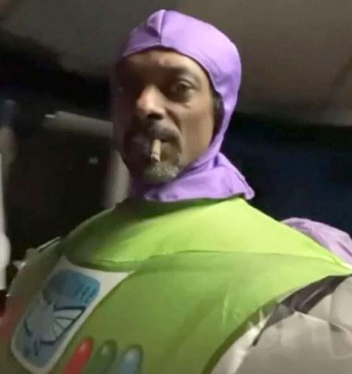 Person in a colorful costume with a hood, creating a weird image worth seeing in a humorous context.