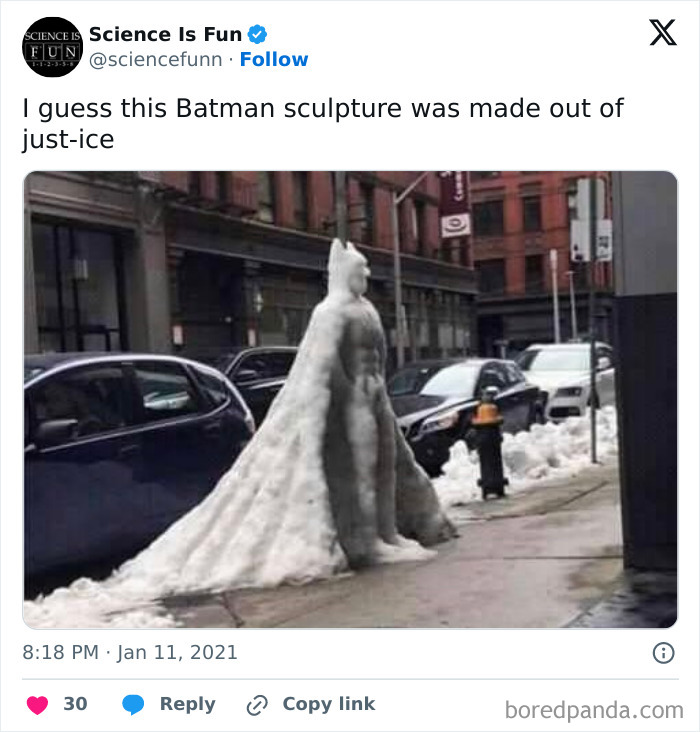 Snow sculpture of Batman on a city sidewalk, embodying hilariously random memes theme.