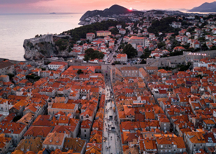 Aerial view of a European town at sunset highlighting cultural architecture.