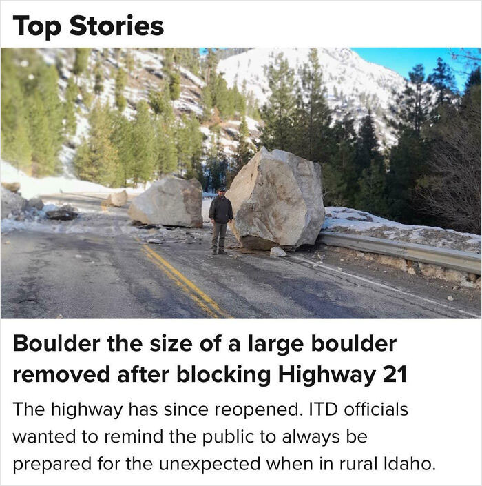 Man standing near a giant boulder on a mountain road after a hilarious news headline incident in Idaho.