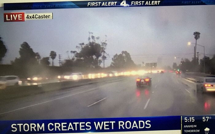 Rainy highway scene with cars, showcasing a hilarious-news-headlines moment about wet roads.