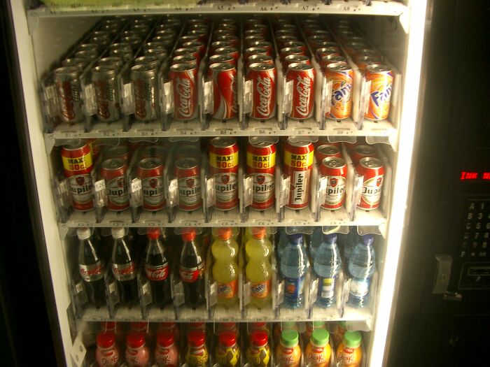 Vending machine filled with various drink cans and bottles, illustrating a common culture shock in different countries.