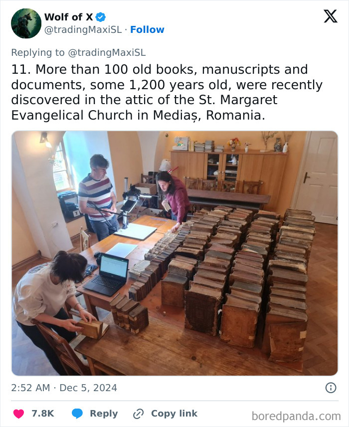 People examine 1200-year-old archaeological finds of books in a church attic in Mediaș, Romania.