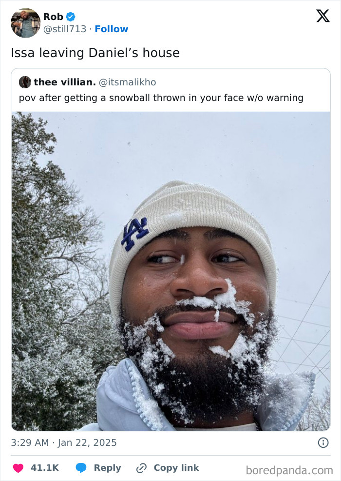 A man with snow on his face looks amused, celebrating Black culture humor in a snowy setting.