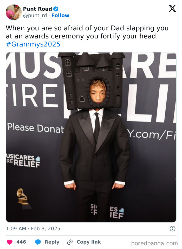 Man at the 2025 Grammys wearing a suit and castle helmet, standing in front of a backdrop, showcasing a viral meme moment.