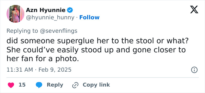 Tweet criticizing Millie Bobby Brown for awkward fan photo, questioning her choice to remain seated. Tweet criticizing Millie Bobby Brown for awkward fan photo, questioning her choice to remain seated.