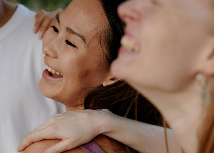 People smiling together, showcasing positive moments despite being overweight.