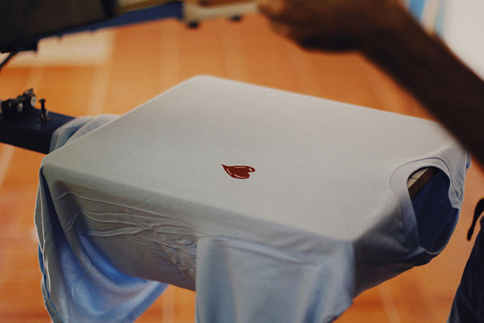 Screen printing a white T-shirt as a side hustle idea.