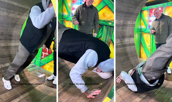 Two men in an amusement park tunnel, one struggling to maintain balance, embodying the real crisis, not emergency handlers.