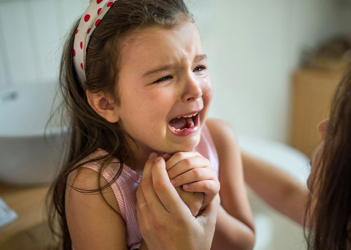 Child crying, being comforted; expressing fear and distress.