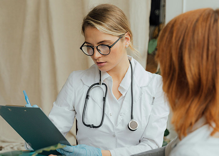 Medical professional with a stethoscope reviewing notes, related to culture shocks experienced by Americans in Europe.