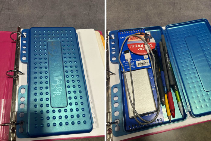 Blue plastic pencil case from the 2000s, attached to a binder, with pens and a small notebook inside.