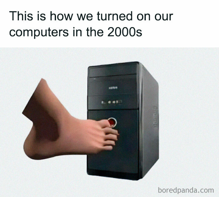 Foot pressing power button on a 2000s computer tower, capturing nostalgic 2000s humor.