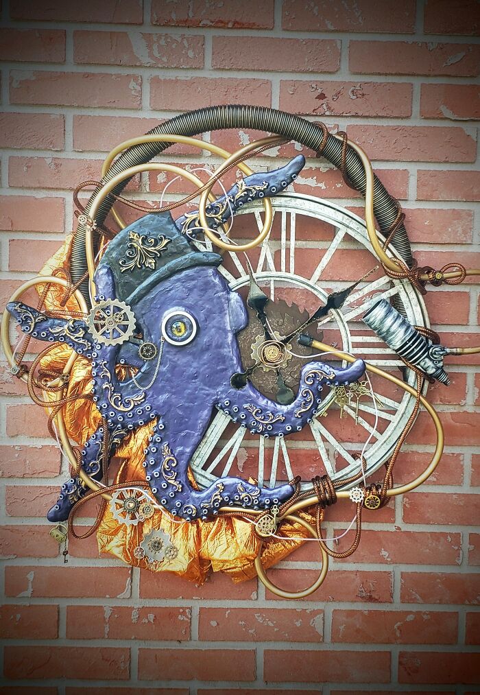 Steampunk octopus decoration with gears and coils on a brick wall.