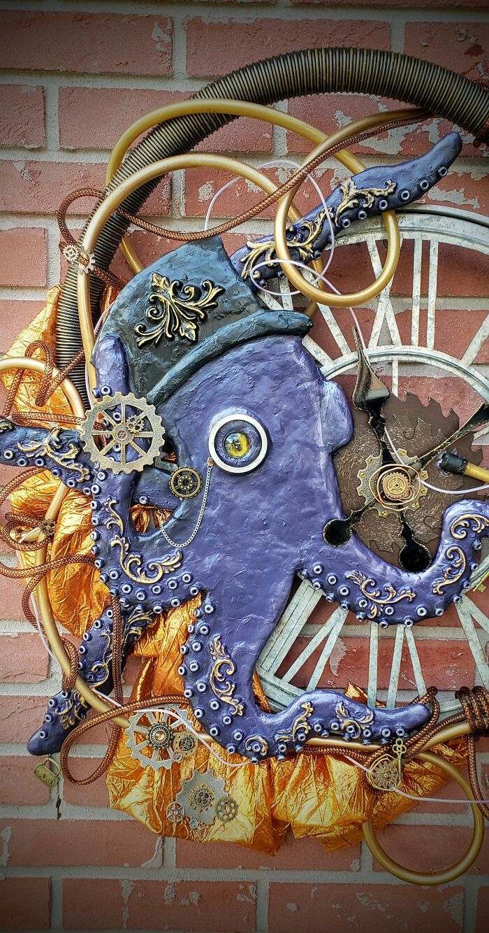 Steampunk octopus decoration with gears and intricate details set against a brick wall.