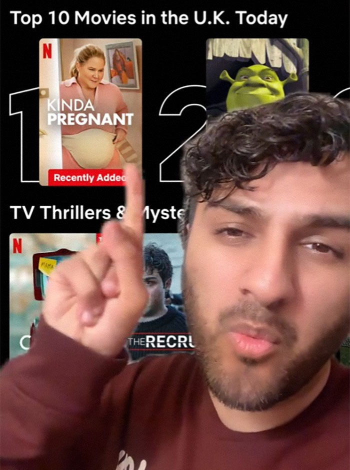 Netflix screenshot showing "Kinda Pregnant" starring Amy Schumer at top spot, with a person pointing at it.