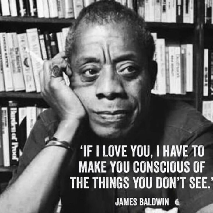 A person in contemplation next to shelves, with an anti-capitalism quote about awareness.