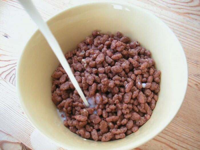 Bowl of chocolate cereal with milk being poured, evoking nostalgic memories akin to songs as ringtones.