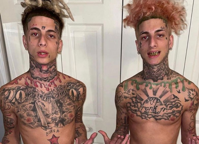 Two tattooed individuals with distinctive hairstyles, highlighting sing-related critique.