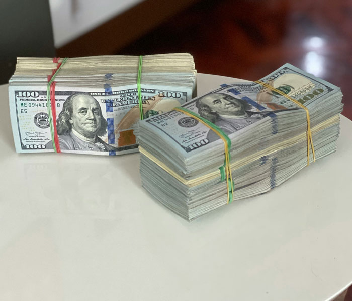 Stacks of hundred-dollar bills, symbolizing rich people's wealth and detachment from reality.