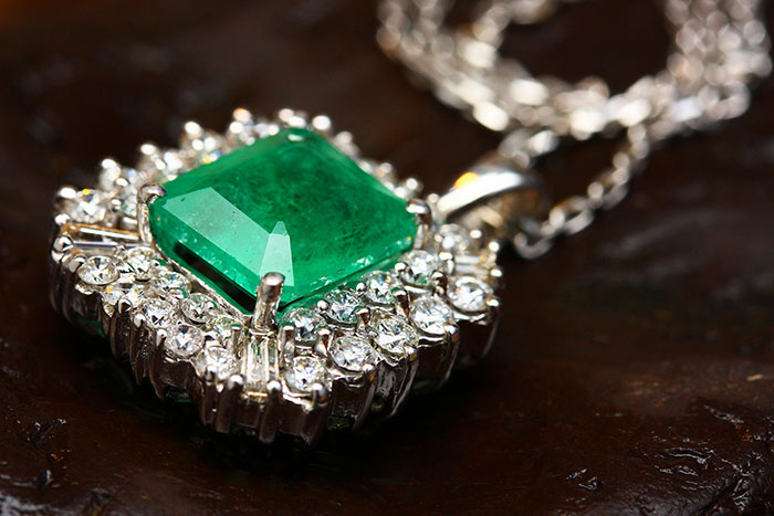 Emerald necklace with diamond accents, representing side hustle ideas for women in jewelry-making.
