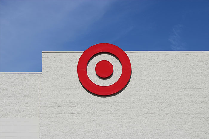 Target store logo against a clear blue sky, symbolizing safe side hustle opportunities.