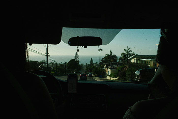 View from inside a car heading towards the ocean.
