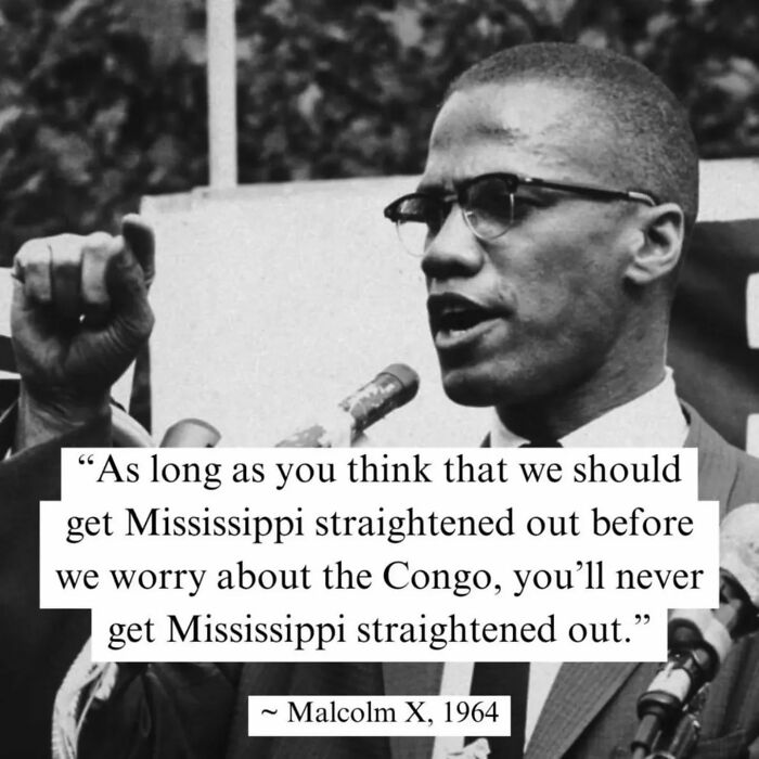 Anti-capitalism quote by Malcolm X, 1964, addressing social justice issues with a powerful speech and a raised fist gesture.