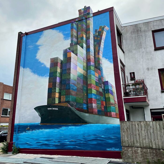 Mural by Jan Is De Man depicting a ship with towering colorful containers creating a stunning hyperrealistic illusion.