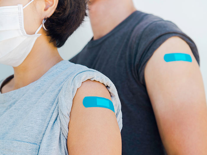 People with band-aids on arms after Covid vaccines.