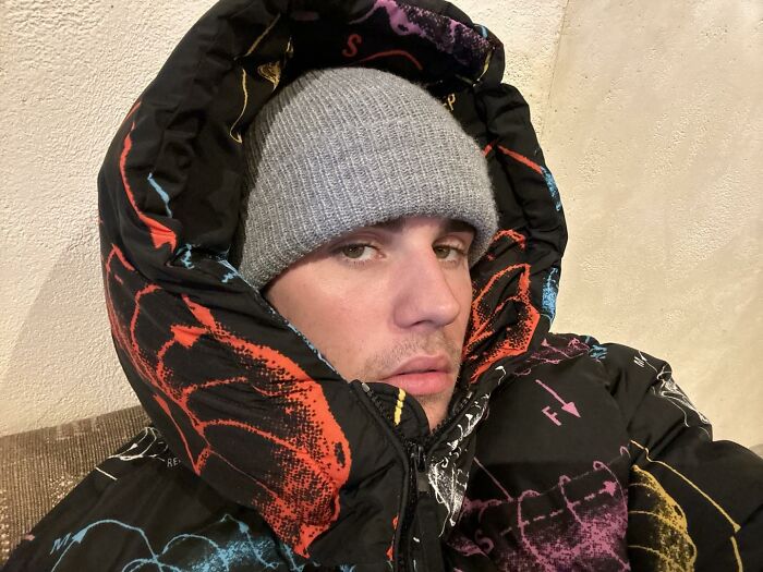 Person in a colorful jacket and grey beanie, linked to celebrity curiosity theme.