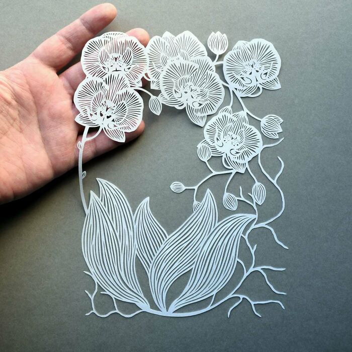 Intricate paper art design of flowers and leaves, hand-crafted with precision, showcasing nature-inspired creativity.