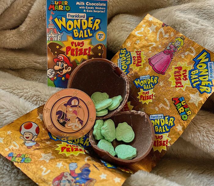Wonder Ball candy from the 90s and 2000s, with chocolate shell, toy coin, and candy shapes on a wrapper.