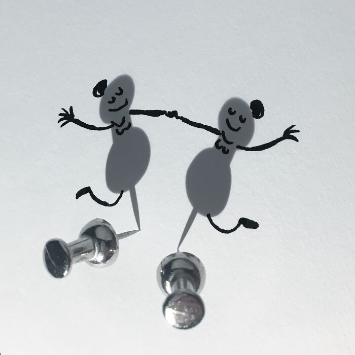 Artist transforms shadows of pushpins into dancing characters with illustrations.