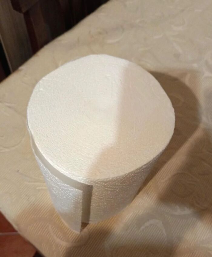 A roll of toilet paper humorously placed on a beige patterned surface, part of Interesting-Images-Cultureavenue.