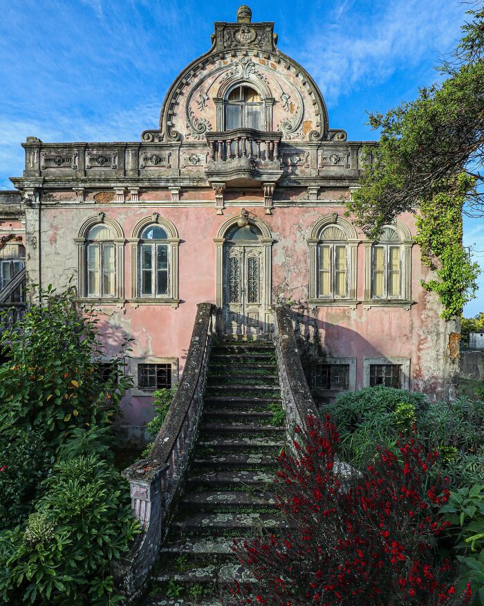 Abandoned villa with overgrown plants, showcasing nature reclaiming civilization.