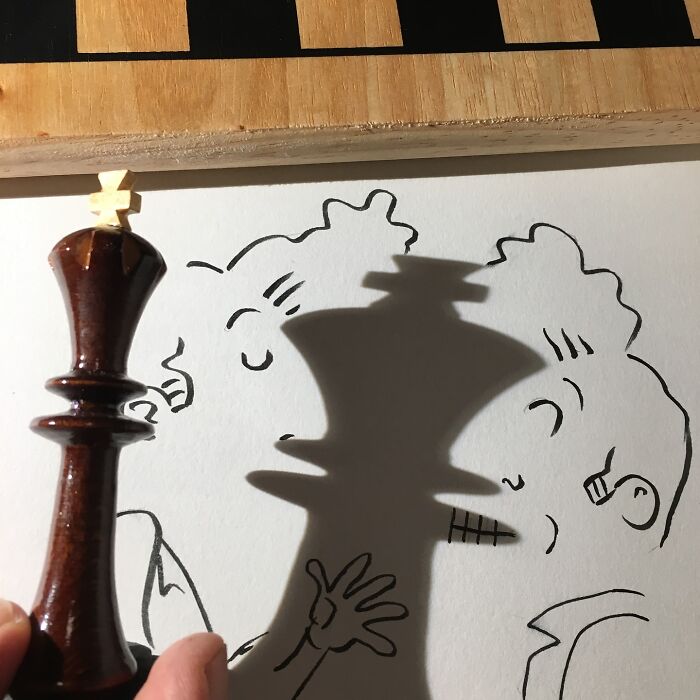 Chess piece casting shadow resembling cartoon illustration, showcasing creative transformation of everyday object shadows.
