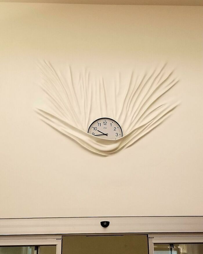 Wall clock with a creative fabric design, showcasing interesting images.