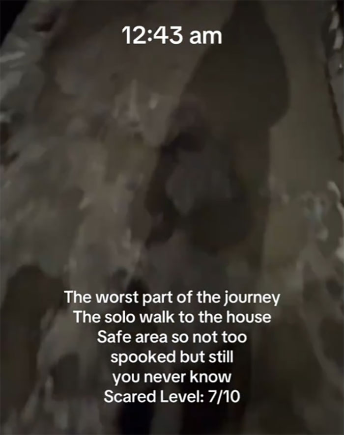 Woman walking alone in NYC at midnight, with text overlay rating fear level as 7/10.