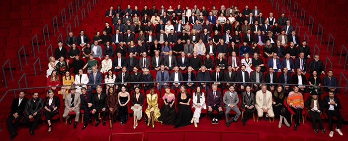 2025 Oscars nominees group photo with limited diversity on red auditorium seats. 2025 Oscars nominees group photo with limited diversity on red auditorium seats.