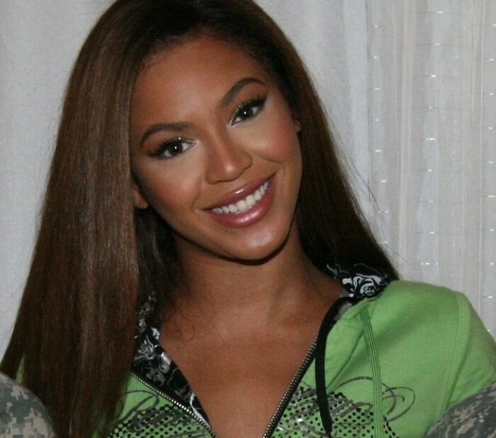 Smiling woman in a green top representing a pop culture moment.