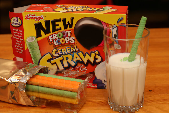 90s and 2000s food item: Froot Loops Cereal Straws with milk on a table.